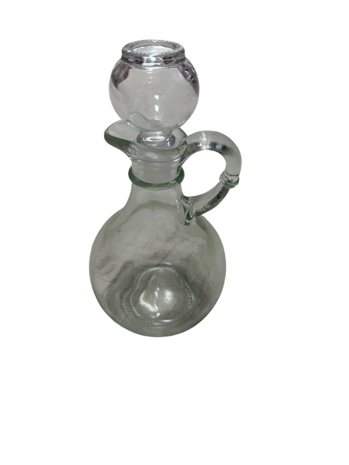 TP BEAUTY SUPPLY PTY LTD clear glass oil and vinegar cruet with a rounded body, ergonomic handle, and glass stopper.