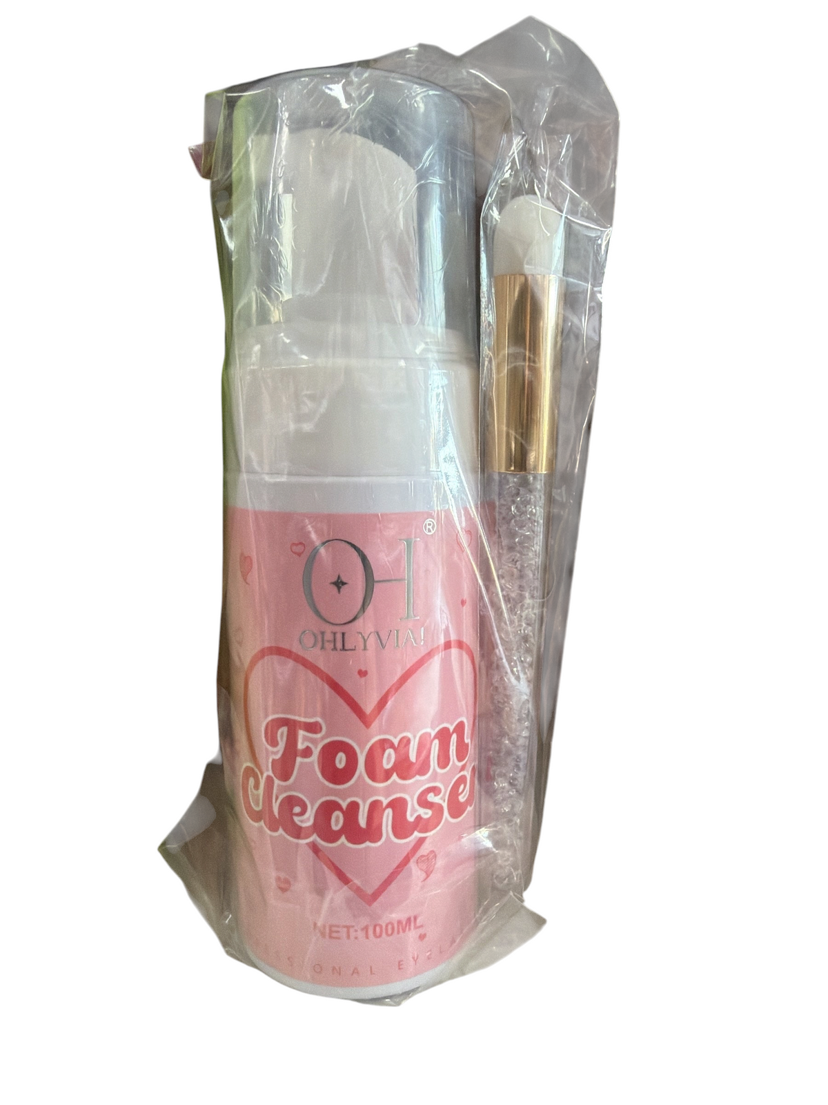 TP BEAUTY SUPPLY PTY LTD OHLYVIA foam cleanser bottle with a crystal-handle application brush in clear packaging.