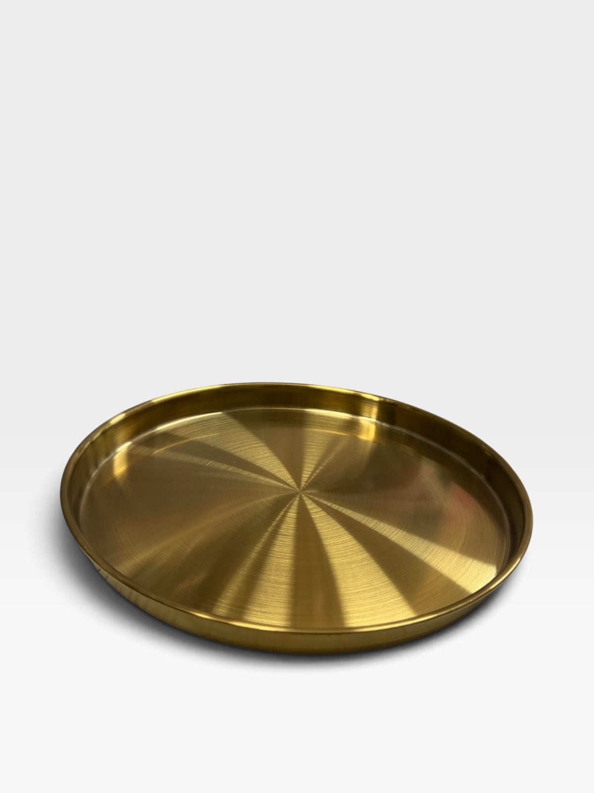 TP BEAUTY SUPPLY PTY LTD round brass serving tray with a brushed gold finish and radial texture on a white background