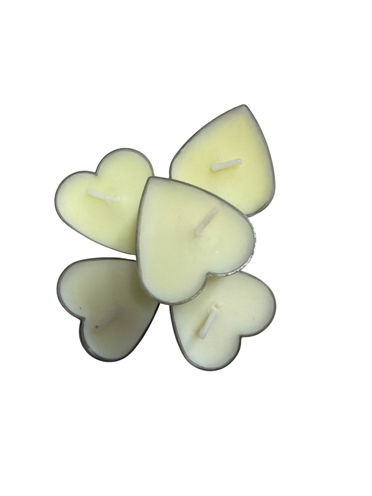 TP BEAUTY SUPPLY PTY LTD creamy yellow heart-shaped tea light candles arranged on a textured grey surface.